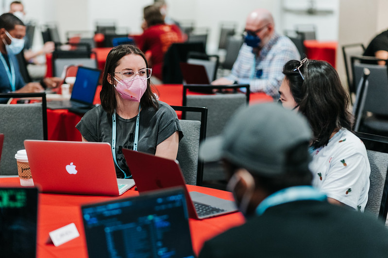 Two Development Sprints attendees at DjangoCon US 2022 in San Diego, chatting. And one of them is now our conference co-chair!